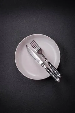 Bumpy empty ceramic plate on a textured concrete background Bumpy empty ce... 写真素材