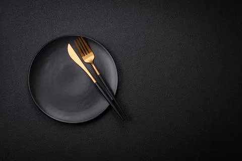 Bumpy empty ceramic plate on a textured concrete background Bumpy empty ce... 写真素材