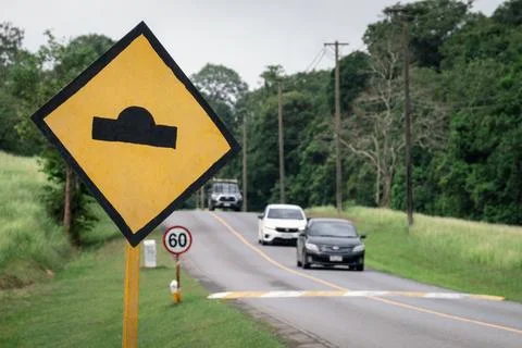 Bumpy road ahead sign, speed bump traffic sign Stock Photos
