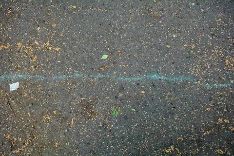 Bumpy road with chalk blue line marking of gray cracked asphalt. Travel conce 写真素材