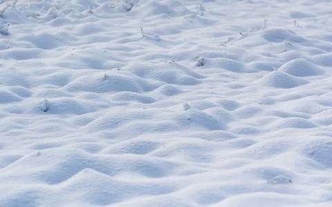 Bumpy snow cover over field close up 스톡 사진