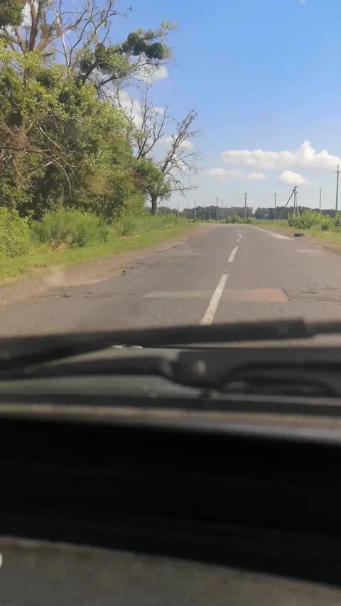 A bumpy summer drive on a deteriorated asphalt road Video stock 282946048