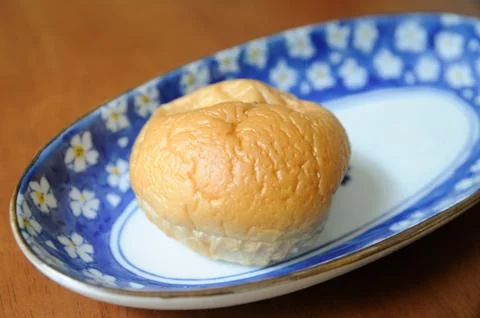 A bun bread in dish on the table. Stock Photos