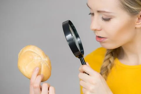 Bun bread roll and magnifying glass Stock Photos
