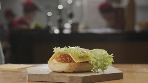 Bun falling on chicken burger in slow motion Stock Footage 120082135