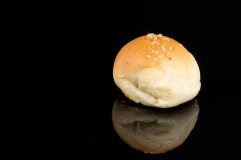 Bun roll isolated on the black background with reflections and c Stock Photos