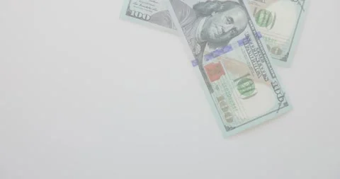 Bunch of 100 dollars bills are falling on a white background. Pile of Unite.. Stock Footage 297040129