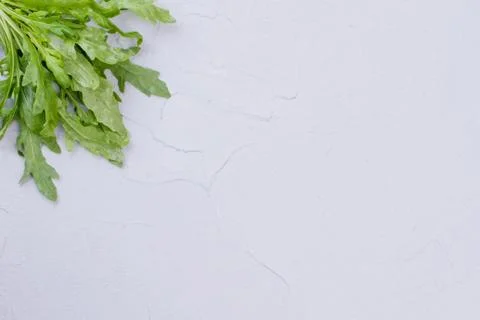 Bunch of arugula in corner, copy space. Stock Photos