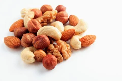 A bunch of assorted nuts on a white background. Healthy food and snacks. Stock-Fotos