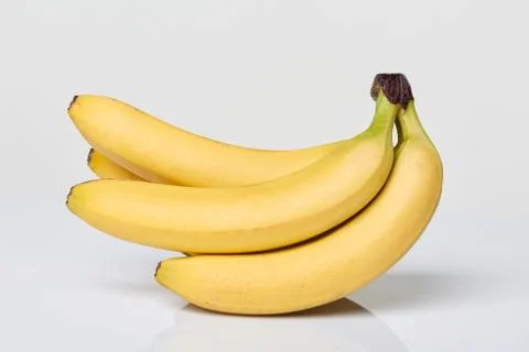 Bunch of bananas on white table Stock Photos