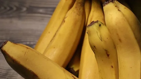 Bunch of bananas on wooden table Stock Footage 170774643