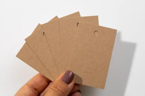 Bunch of blank cardboard rectangular label tags for clothes looking together Stock Photos