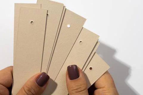Bunch of blank cardboard rectangular tags with tiny holes in upper part in 스톡 사진