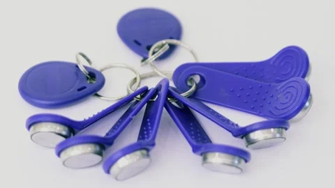 Bunch of blue magnet keys on ring rotate isolated on white Stock Footage 276375685