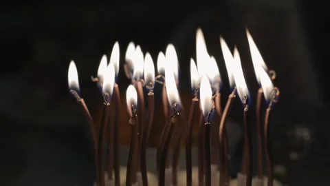 A bunch of candles are lit up in a dark room Stock Footage 297650043