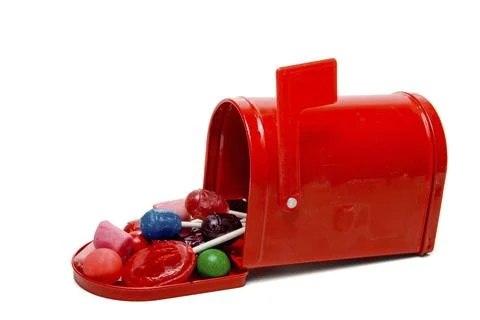 A bunch of candy stuffed into a mailbox Stock Photos