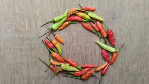 A bunch of cayenne pepper (cabe rawit) with a wooden texture background Stock Footage 297239380
