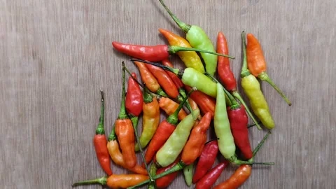 A bunch of cayenne pepper (cabe rawit) with a wooden texture background 動画素材 297239381