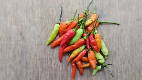 A bunch of cayenne pepper (cabe rawit) with a wooden texture background 動画素材 297239753