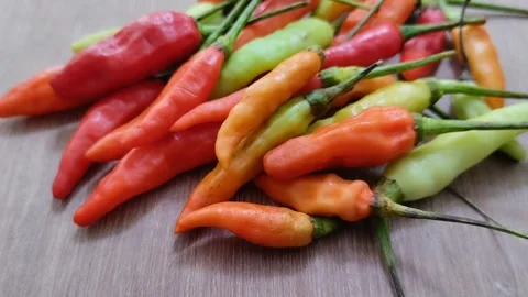 A bunch of cayenne pepper (cabe rawit) with a wooden texture background 動画素材 297239754