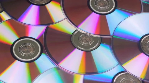 Bunch Of CD Discs Rotates Reflecting Light Stock Footage 100379764