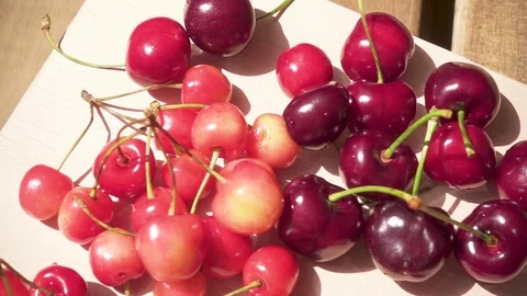 A bunch of cherries and cherry juice on a table Video stock 90652115