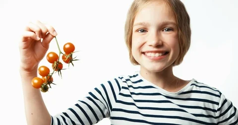 Bunch of cherry tomatoes in hands of child Video stock 85698647