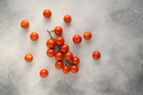 Bunch of cherry tomatoes on white stone concrete table, top view with copy space Stock Photos