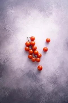 Bunch of cherry tomatoes on white stone concrete table, top view with copy space Stock Photos