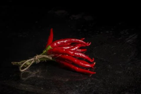 Bunch of chilli pepper on old worn iron rusty tray Stock Photos