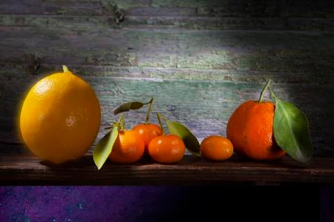 Bunch of Citruses In Sharp Light on Shelf Stock Photos