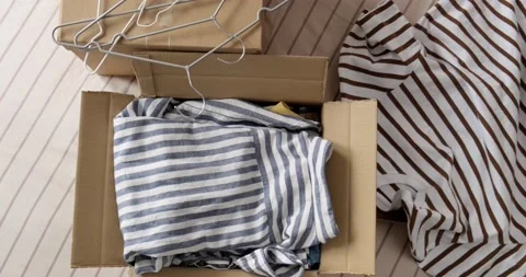Bunch of clothes being packed in box, donation concept. Stock Footage 155074852