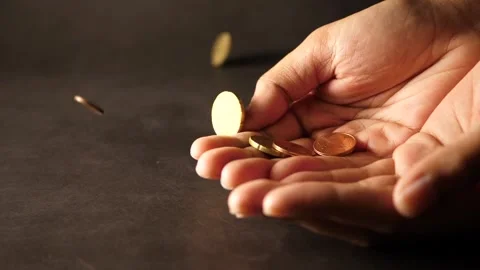 A bunch of coins falling to two hands and to the table close up finance concept Stock Footage 160558876