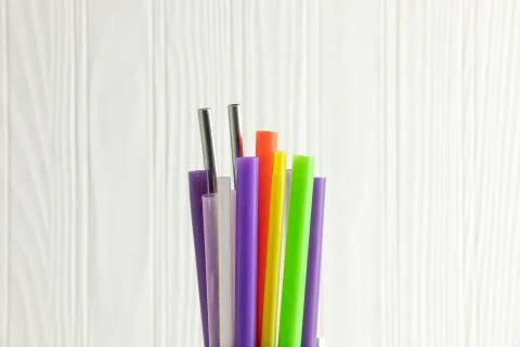 Bunch of colored plastic straws isolated on white background close up. Ban si Stock Photos