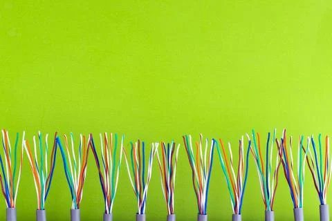 A bunch of colored wires on the background of a light-yellow surface Stock Photos