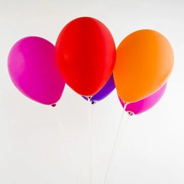 Bunch of colorful balloons isolated in white background. Stock Photos