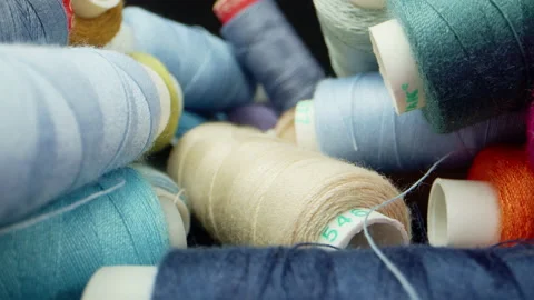 A bunch of colorful coils with close-up threads on a dark background. The Stock Footage 194420327