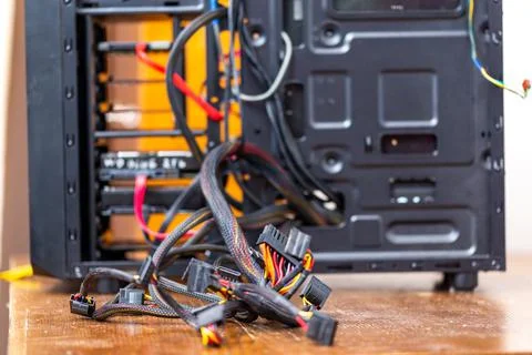 Bunch of computer wires sticking out from opened black pc case - close-up with 库存照片