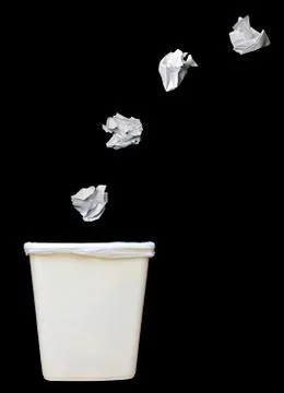 Bunch of crumbled paper being throwing into a trash bin or waste bin isolated Stock Photos