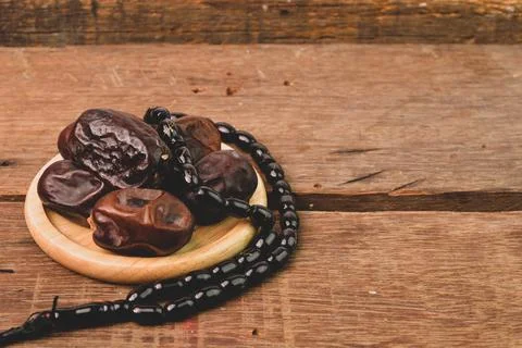 Bunch of dates and Islamic prayer beads with copy space. Ramadan kareem festi Stock Photos