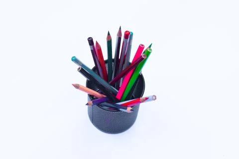 Bunch of different colored pen and pencil crayons gathered in a black pencil Stock Photos