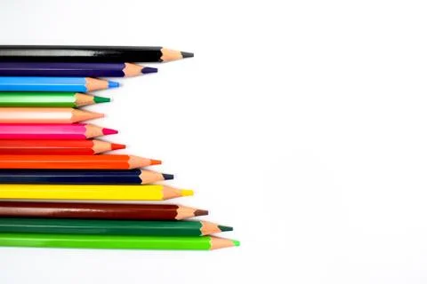 Bunch of different colored wax crayons arranged together making a nice wave w Stock Photos