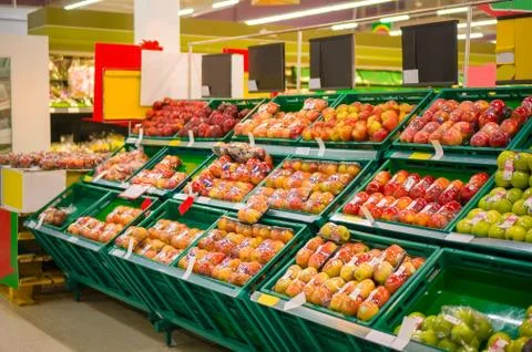 Bunch of different types of red apples in boxes in store Stock Photos