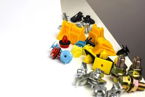 A bunch of differently colored car hardware on the edge of the table. copy sp Stock Photos