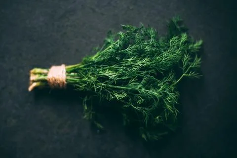 Bunch of dill on a dark granite table. Foto stock