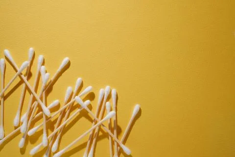 Bunch of disposable cotton buds, using for eyelash extension, isolated on y.. Stock Photos