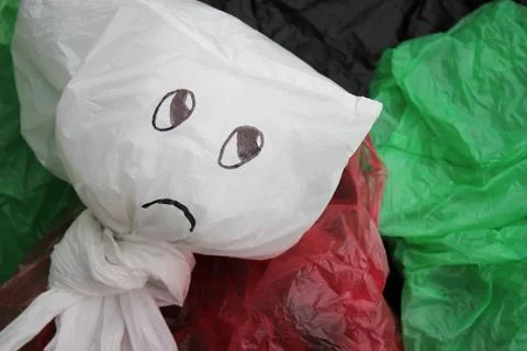 A bunch of disposable, multi-colored plastic bags polluting the environment . Stock Photos