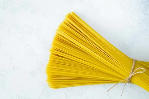 A bunch of dry spaghetti on a light background Stock Photos