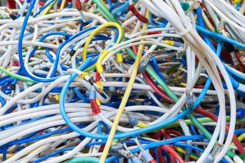 The bunch of electric wires or cables are strongly tangled together. Stock Photos