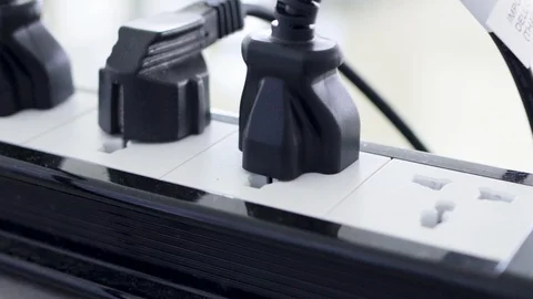 Bunch of electrical plug plugged into the socket on the extension cord Stock-Footage 124649788